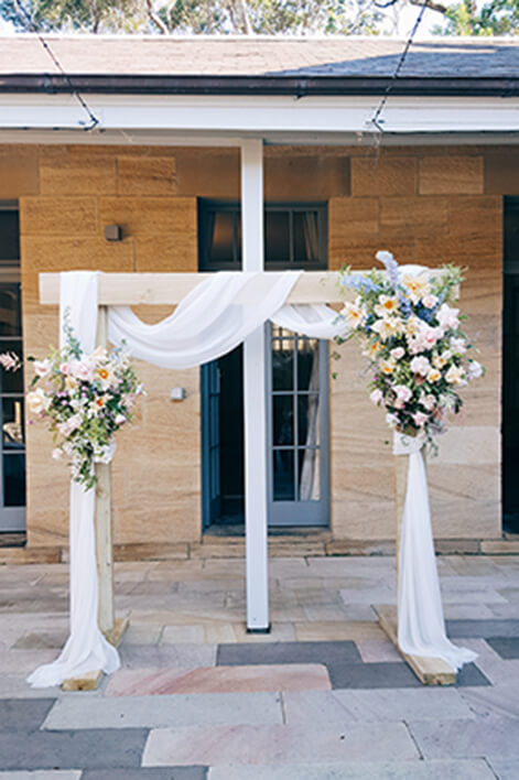 Light Timber Wedding Arch With Drapery